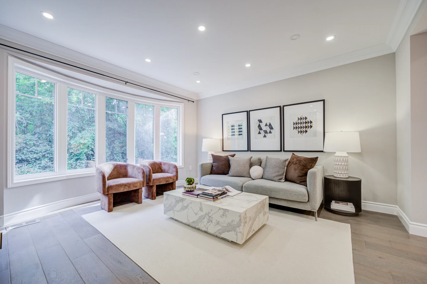 Living room with sofa, chairs and large windows at 30 Elmeade Lane